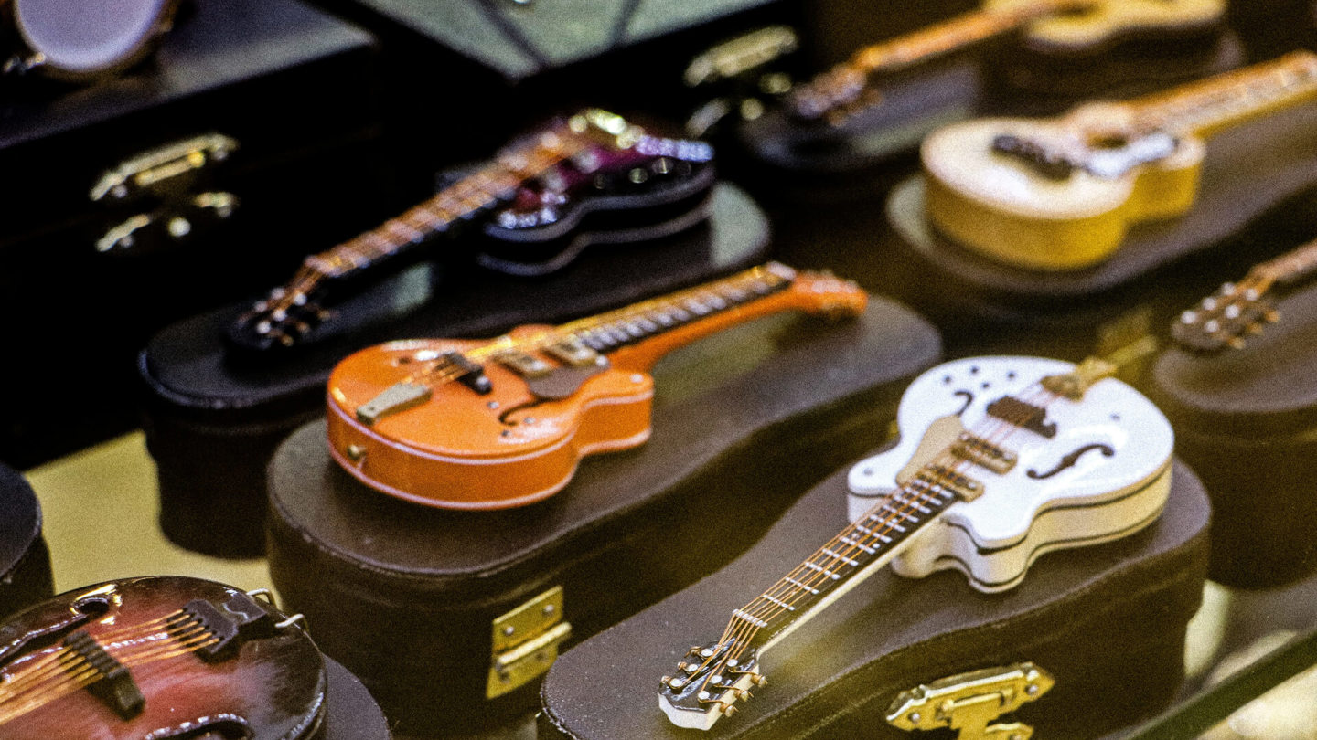 A Display Case Filled with Lots of Guitars